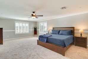 A bedroom with a large bed, a ceiling fan, and two bedside tables with lamps. - Arizona Vacation Rental w/ Patio & Grill! (Corona de Tucson)