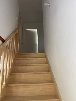 Staircase leads to a cozy interior space with a door at the top.