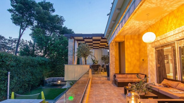A modern outdoor patio area with a pool, seating, and a dining setup. - Beautiful home in Zadar (Zadar)