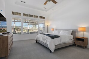 Cozy retreat with a large bed, bedside tables, and a dresser, perfect for a restful stay.