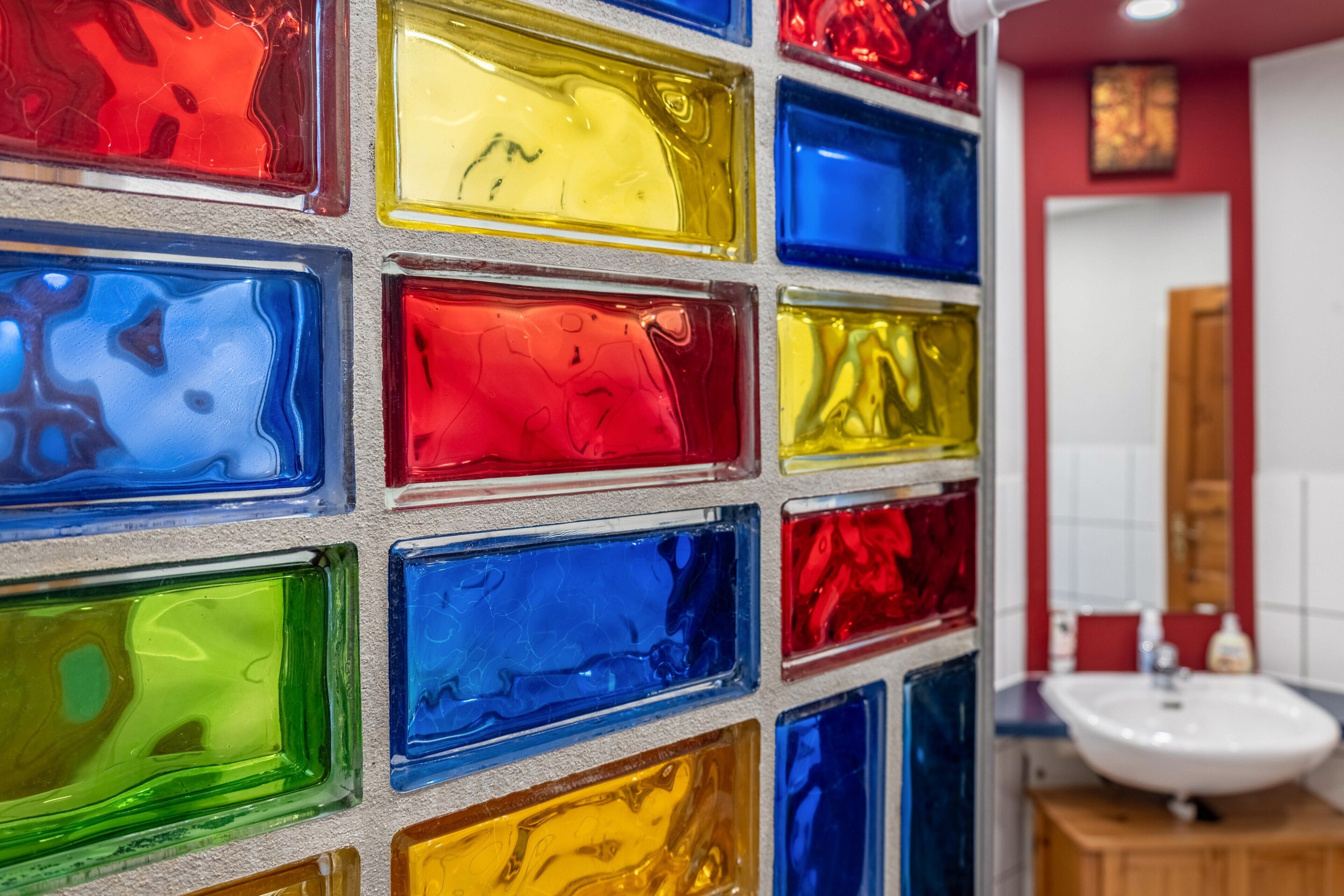 A wall with colorful glass blocks.