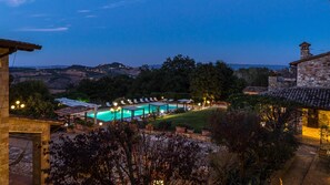 A pool area with lounge chairs and a view of the surrounding landscape. - Residenza Collefiorito 26 Emma Villas (Todi)