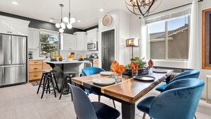 A modern kitchen with white cabinets, stainless steel appliances, and a wooden island. - Red Mountain Villa, Game Room, Community Pool, Smart Tv's (Washington)