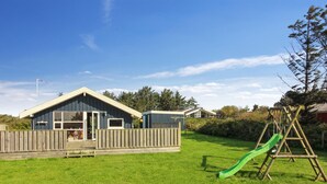 A playground with a slide and a swing set.