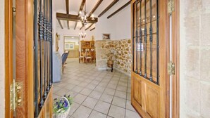 A spacious hallway with tiled flooring, wooden doors with glass panels, and exposed wooden beams on the ceiling. - Casa Germaine by Interhome (Jávea)