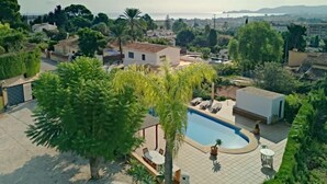 A residential area with a swimming pool, surrounded by lush greenery and houses. - Casa Germaine by Interhome (Jávea)