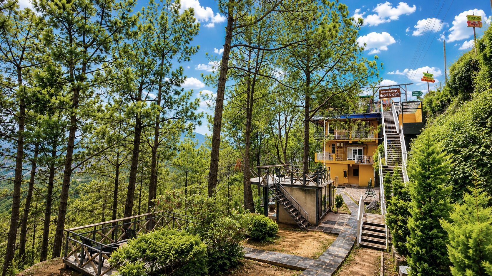A yellow building with a balcony, surrounded by trees and a staircase leading up.