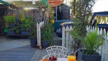 A table with breakfast items, a coffee cup, and a sign for a cafe.