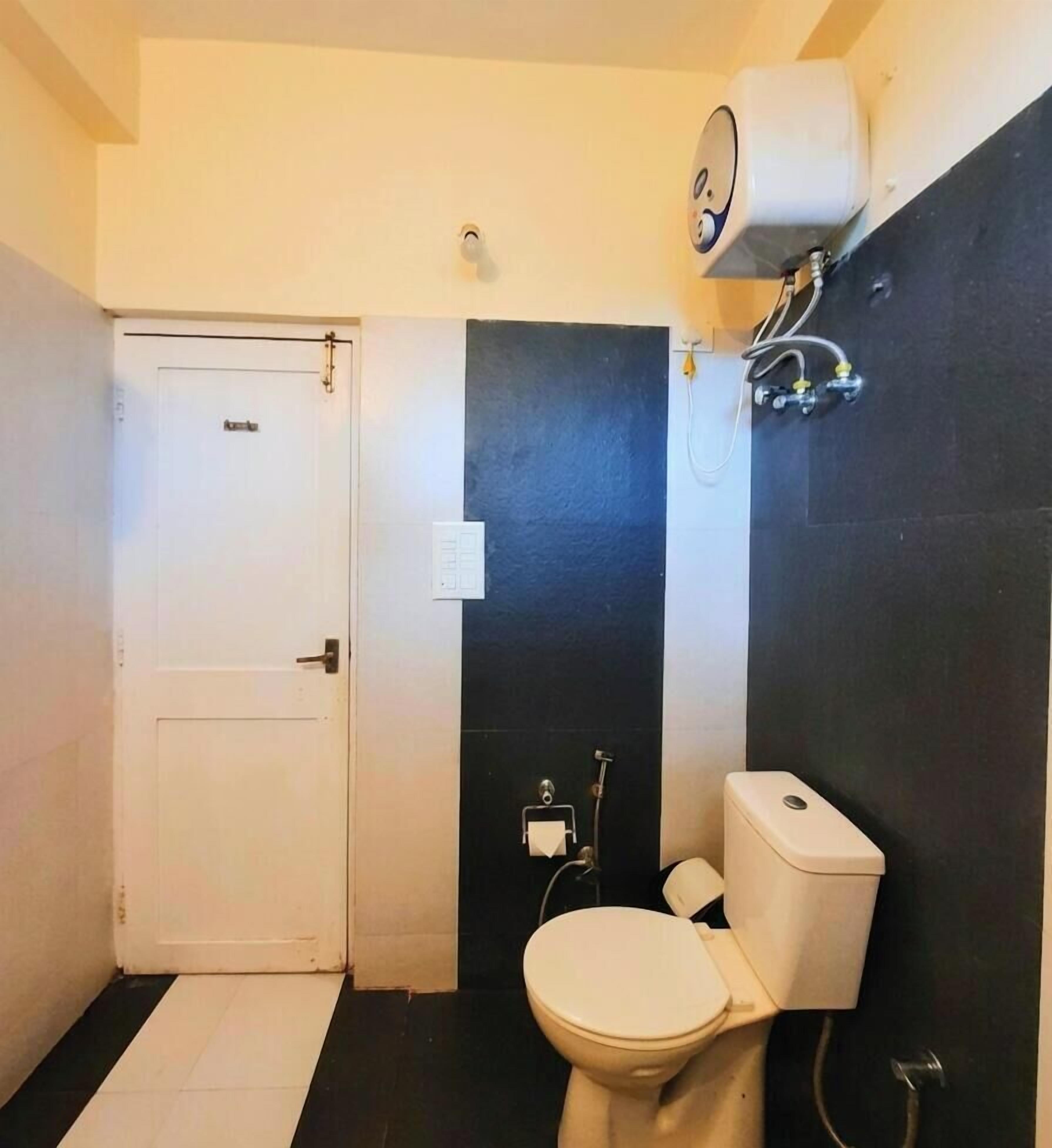 A small bathroom with a toilet, a sink, and a shower.