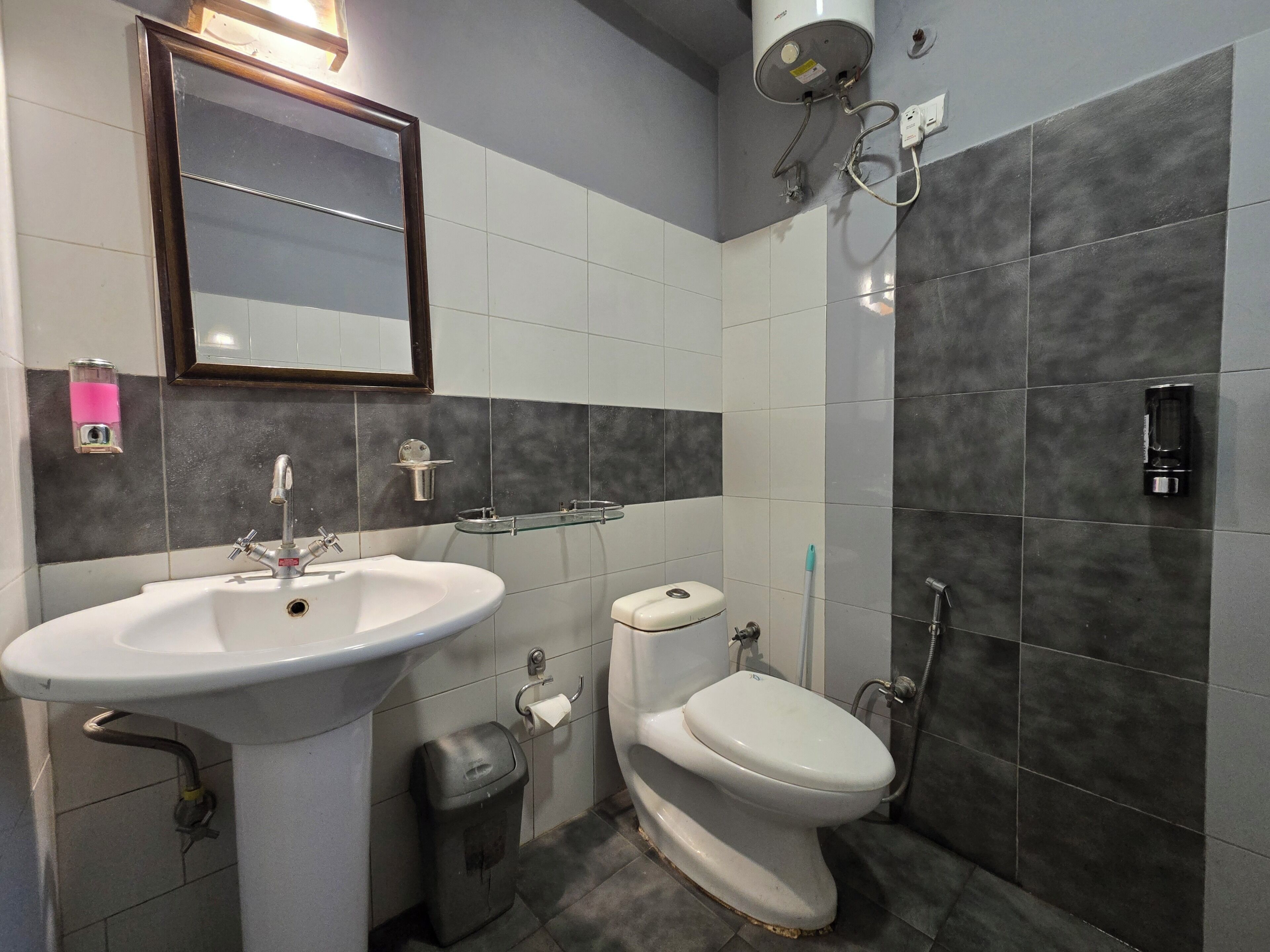 A bathroom with a sink, toilet, and shower.
