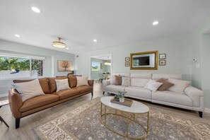 A living room with two sofas, a coffee table, and a television.
