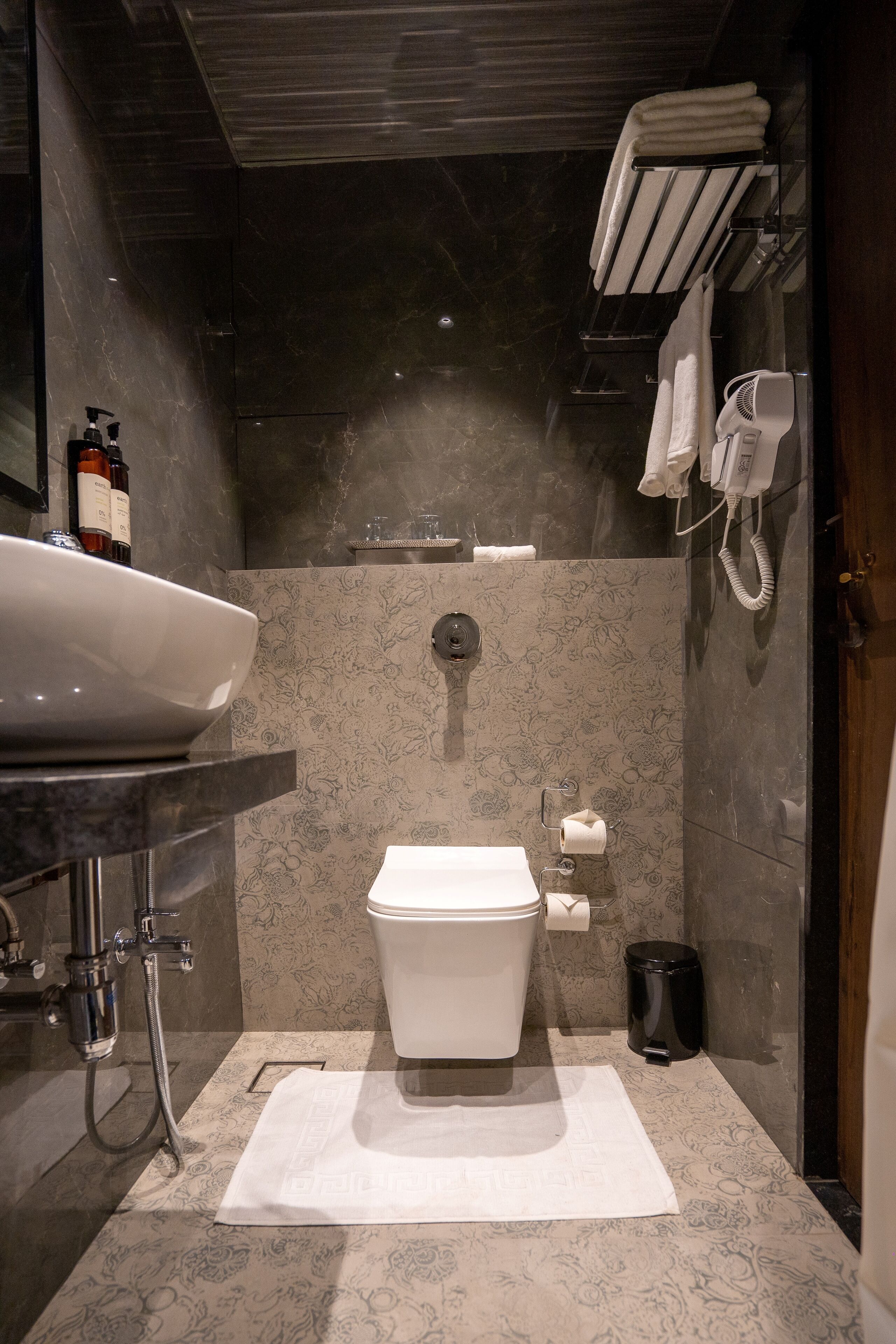 A modern bathroom with a large sink, toilet, and shower.