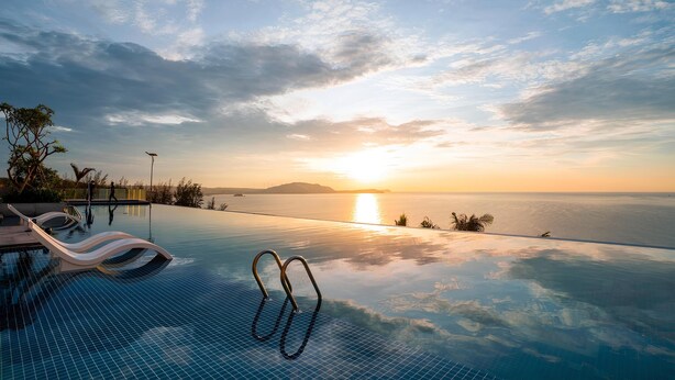 An infinity pool with a view of the sunset over the ocean. - Sunrise Oceanfront Mui Ne - V Ruby (Mui Ne)