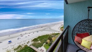 A balcony with a view of a beach and ocean. - Magnificent Oceanfront Suite: 11th Flr (Myrtle Beach)