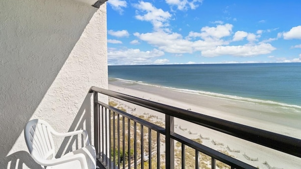 A balcony with a view of a beach and ocean. - Spacious Oceanfront Suite with Breakfast 14th Flr (Myrtle Beach)