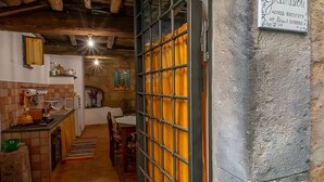 Un interior rústico con vigas de madera a la vista, una zona de cocina y un comedor.