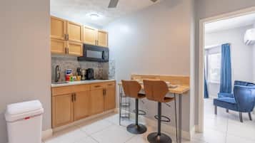 Fridge, microwave, coffee/tea maker, cookware/dishes/utensils