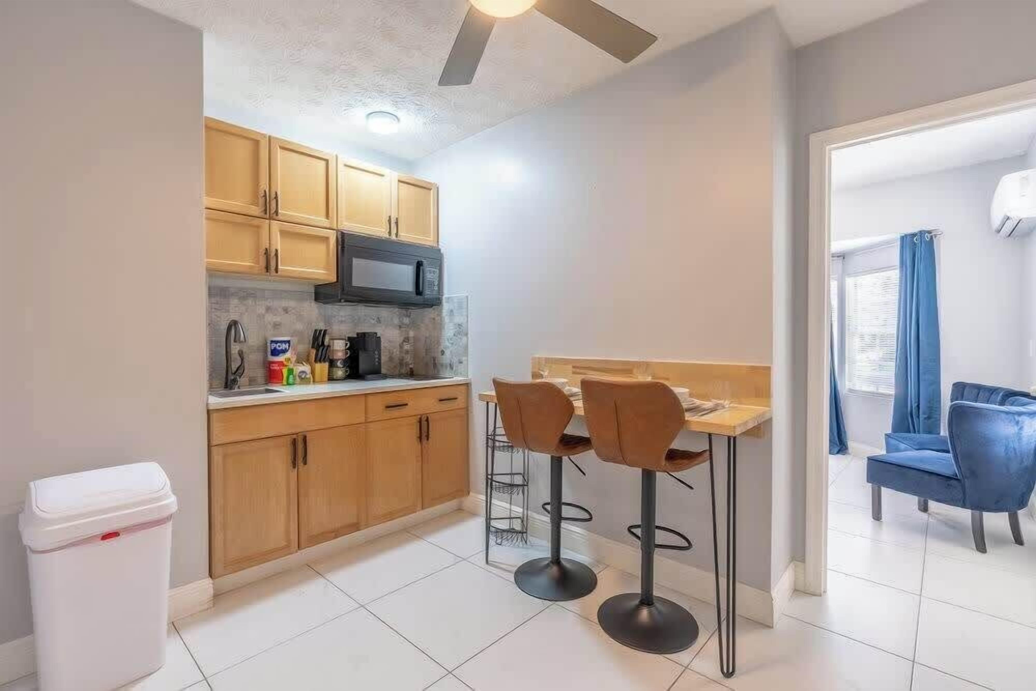 Fridge, microwave, coffee/tea maker, cookware/dishes/utensils