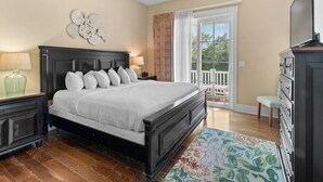 A bedroom with a dark wood bed, white bedding, a green vase on a nightstand, a dresser, and a large window with a view of the outdoors. - Modern 1 Bedroom Luxury Flat Your Stylish Oasis (North Myrtle Beach)