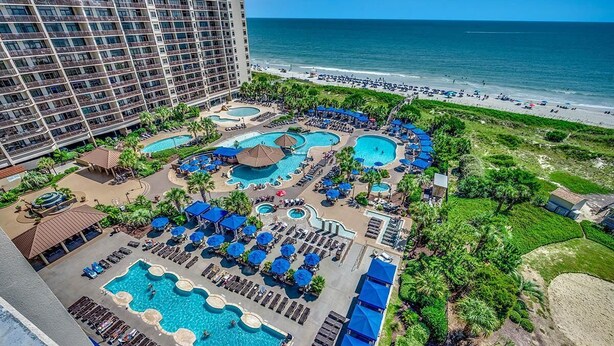 A resort with multiple swimming pools, beach access, and a large hotel building. - Luxury Oceanfront 4 Bedroom Condo: Sleeps 12 (North Myrtle Beach)