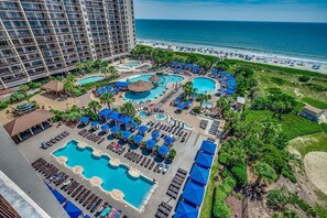 A resort with multiple swimming pools, sun loungers, and a beach view. - Unwind in Luxury : Oceanfront 4 Bedroom Condo (North Myrtle Beach)