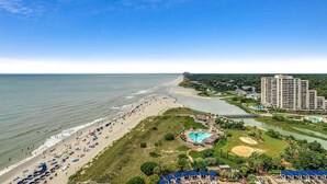 A coastal resort with a beach, a swimming pool, and a golf course. - Seaside Splendor: Oceanfront Four Bedroom Gem (North Myrtle Beach)
