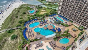 A resort with multiple swimming pools, a beach, and a large building. - Seaside Splendor: Oceanfront Four Bedroom Gem (North Myrtle Beach)