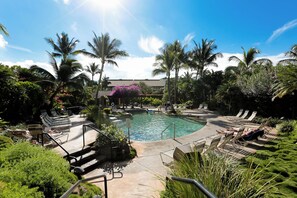 A pool area with lounge chairs and palm trees. - Maui Kamaole #A-104 Front Row, Ocean View, Across Kamaole Bch III, Full A/C (Kihei)