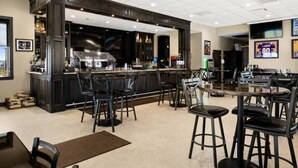 A modern bar area with a dark wood bar counter, multiple stools, and a seating area with tables and chairs.
