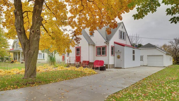 A two-story house with a red front door, a garage, and a driveway. - Harmony Home w/ Fire Pit: 5 Mi to Niagara Cave! (Harmony)