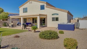 A two-story house with a patio, outdoor seating, and a hot tub. - Corona De Tucson Home With Hot Tub! (Vail)