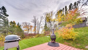 A red deck with a barbecue grill and a decorative vase. - Lake Superior Getaway - Walk to Water! (Duluth)
