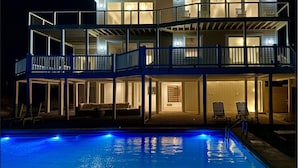 A multi-story house with a pool, featuring balconies and a covered patio area. - Oceanfront 10 bdrm w/Pool/Elevator on The Point. Best Views on the Island! (Emerald Isle)