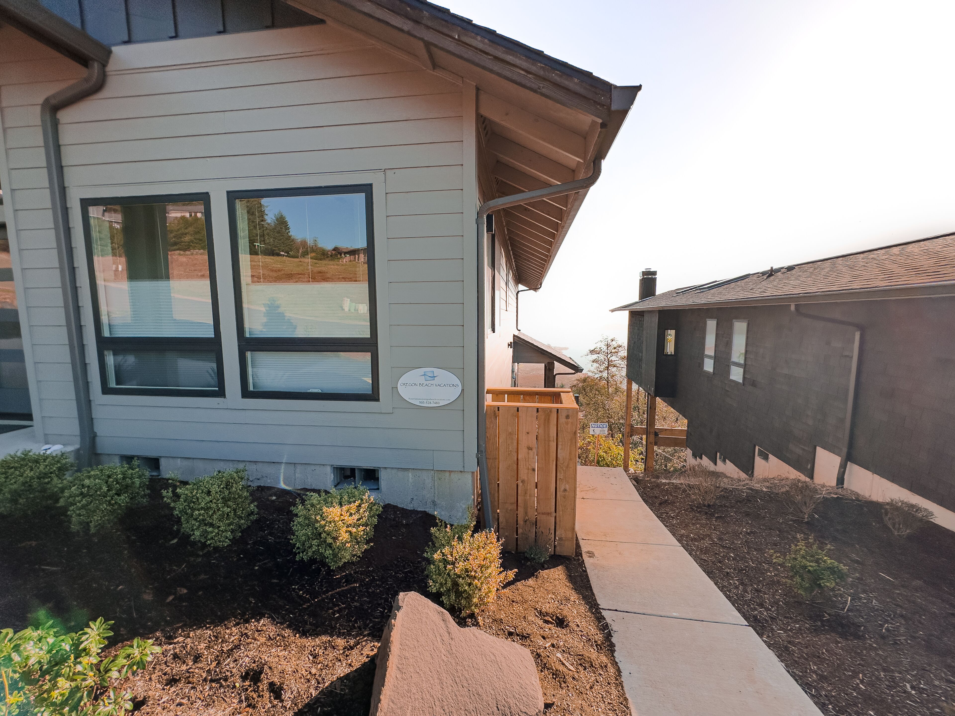 A two-story building with a sign for 'Oregon Beach Vacations' and a 'No Trespassing' sign.