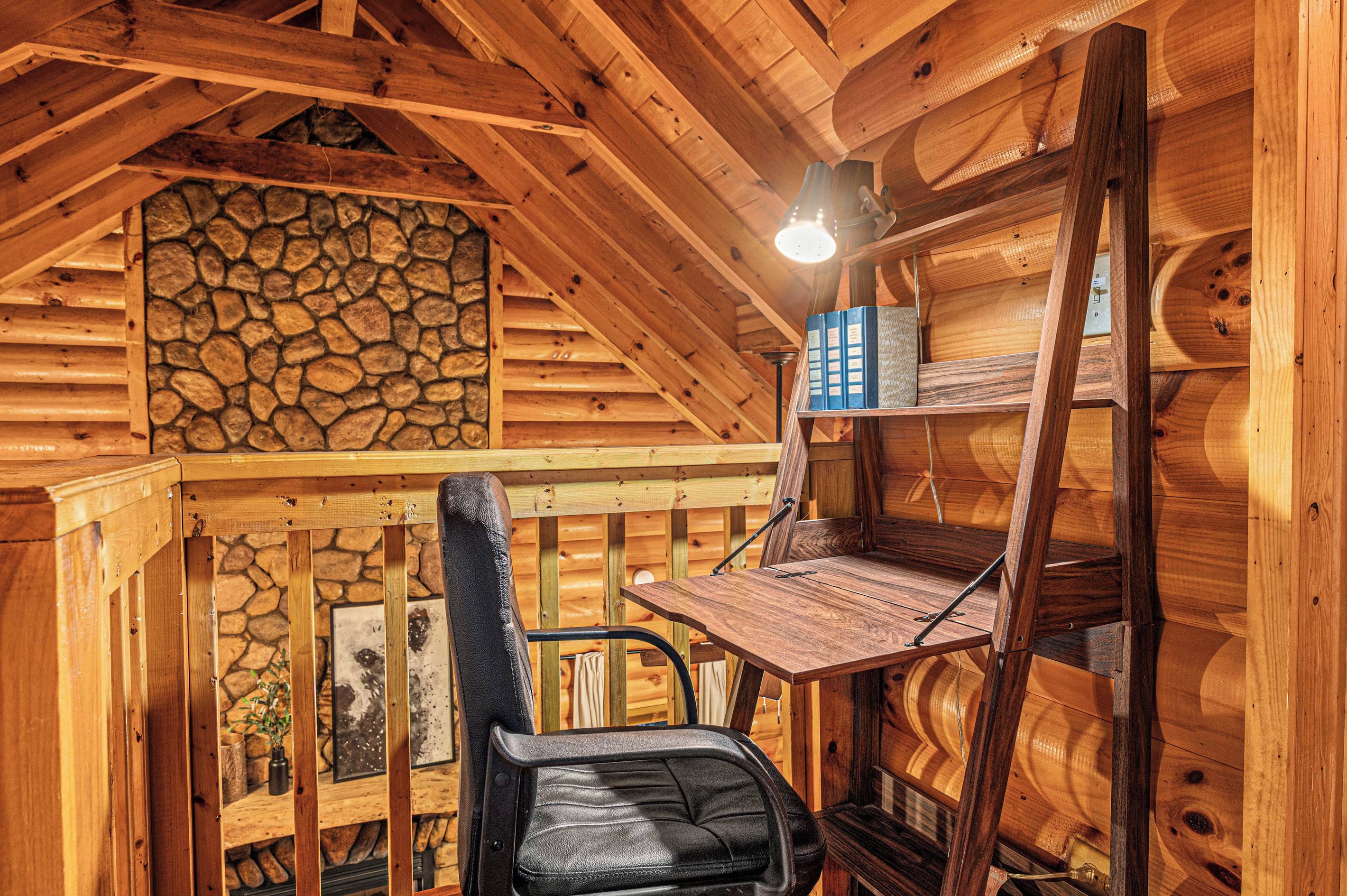 A wooden interior with a stone wall, a desk, and a chair.