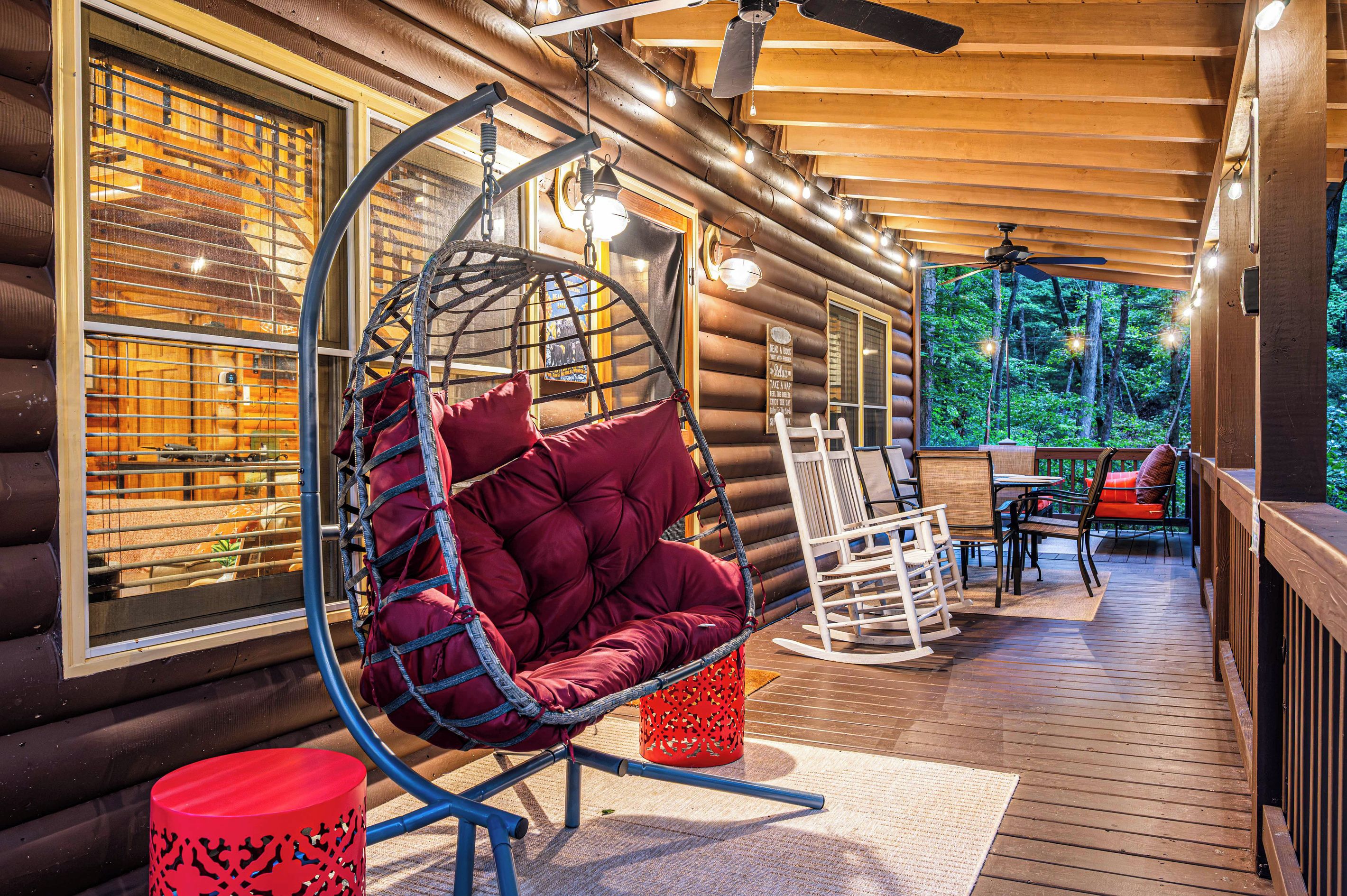 Rock on the covered porch while the ceiling fans turn. Morning coffee, afternoon rain, an evening drink under the string lights — this porch works in any weather.