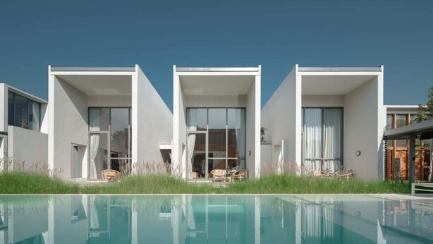 A modern building with a pool in front.