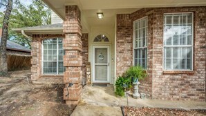 A brick house with a front door, two windows, and a small garden area. - Spacious Brick House 3BR 2BA A+ (Denton)