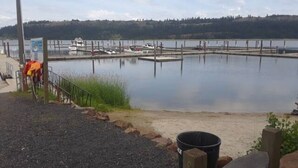 A calm lake with docks, a gravel path, and a signboard. - Best View of the Lake in Harrison (Harrison)