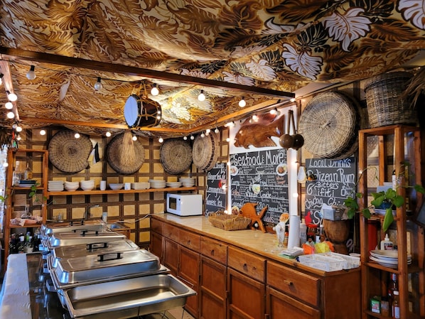 A restaurant interior with a patterned ceiling, buffet counters, and a chalkboard menu.