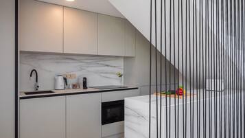 Fridge, stovetop, dishwasher, coffee/tea maker