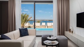 A modern hotel room with a large window offering a view of a pool and beach. - Awesome home in Tkon-Ugrinic (Tkon-Ugrinic)