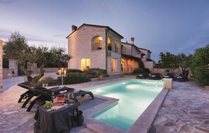 A stone building with a swimming pool, outdoor seating, and a candelabra. - Lovely home in Rovinj with sauna (Rovinj)