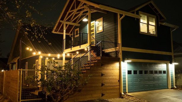 A two-story house with a front porch, a staircase, and a garage. - Gorgeous, one-bedroom garage apartment in a quiet neighborhood (Austin)