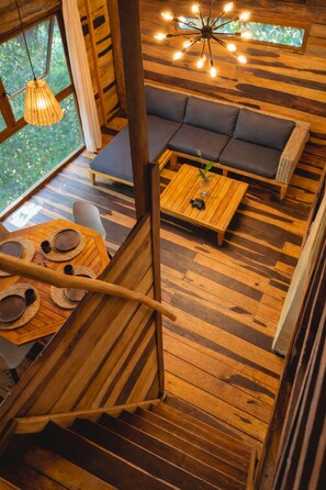 Deluxe Bungalow, 2 Queen Beds, Terrace, Mezzanine | Living area | Books -  Treehouse Tulum H2Ojos (Tulum)