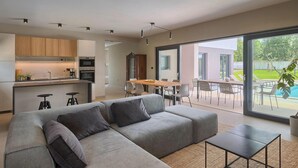 A modern living space with a large sofa, a dining area, and a kitchen. - Awesome home in Vodnjan (Vodnjan)