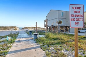 A beach house with a sign indicating it is for owners and guests only. - Family waterfront condo,Dog Friendly, pools, boat launch, beach access, WIFI! (Gulf Shores)