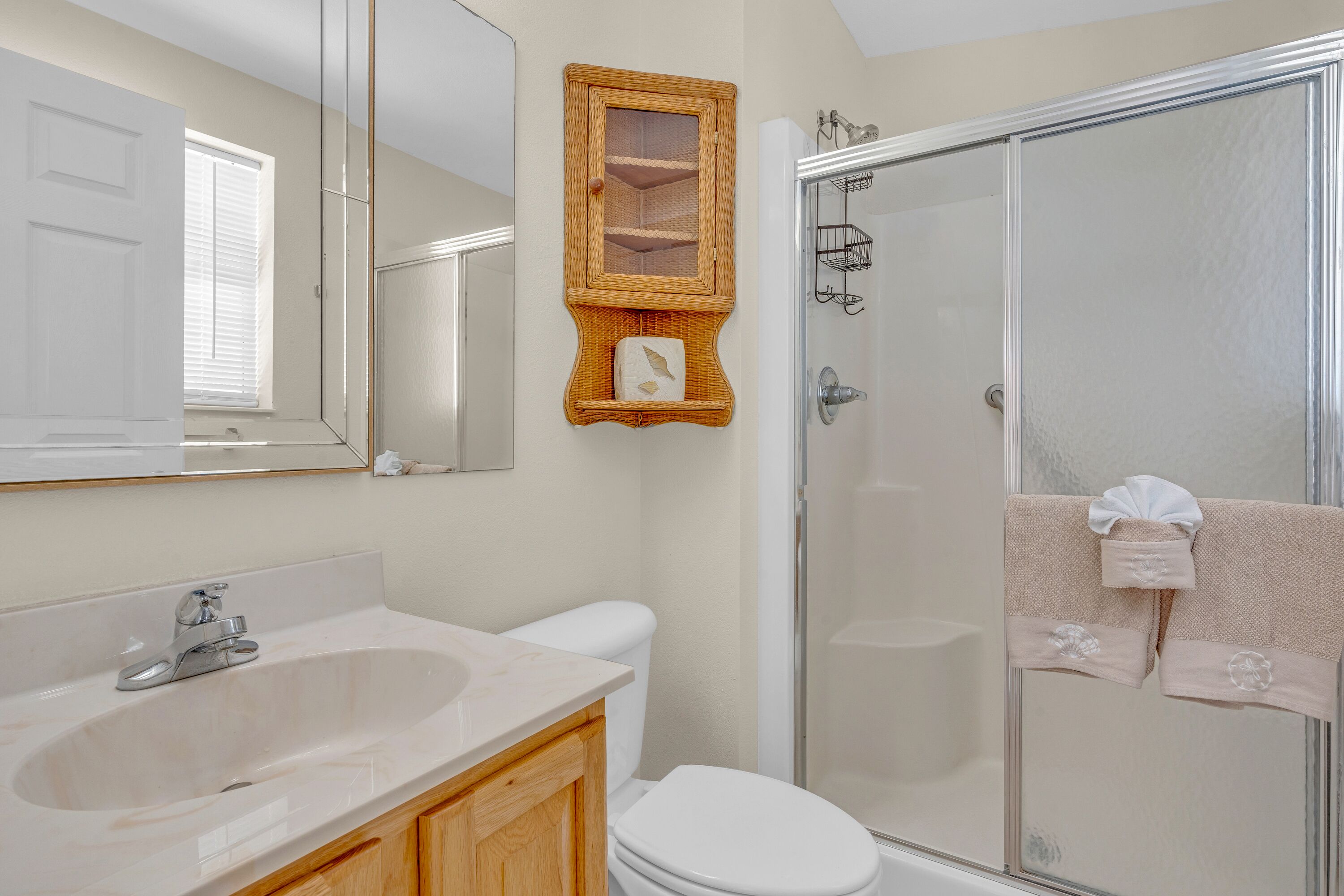 A bathroom with a sink, toilet, and shower.