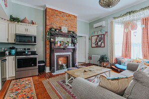 A cozy living room with a fireplace, a sofa, and a coffee table.