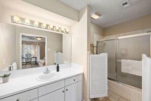 A modern bathroom with a large mirror, vanity, and a walk-in shower. - Spacious Dual Townhomes in Montrose Houston Sleeps 20 (Houston)